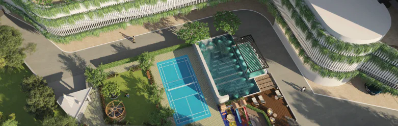 Aerial view of the sports court, pool and green facade at Rustomjee Urban Woods
